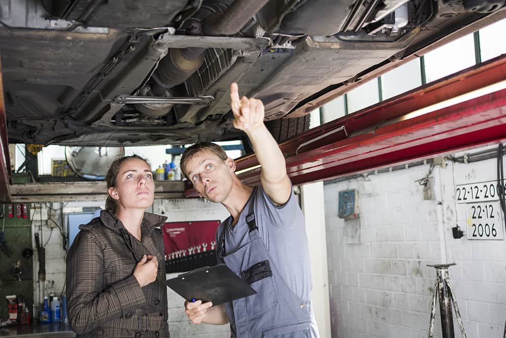 Mechanic pointing with woman